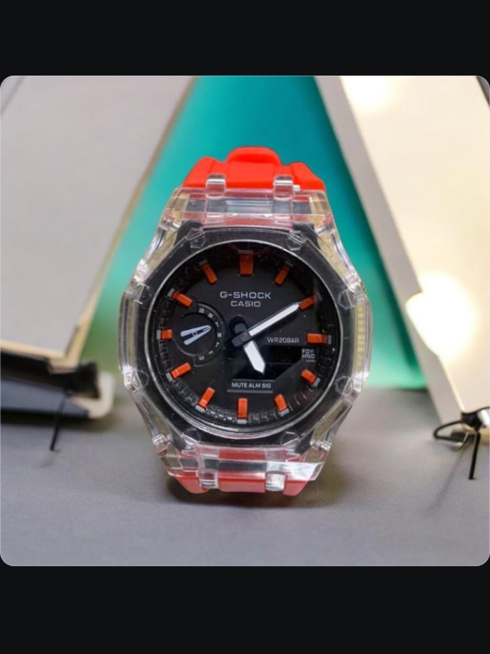 G-Shock Clear Case Red Strap Black Dial Watch with Orange Accents